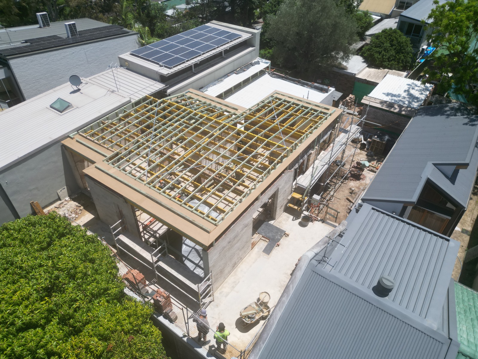 The same project with roof framing and blockwork walls in place.